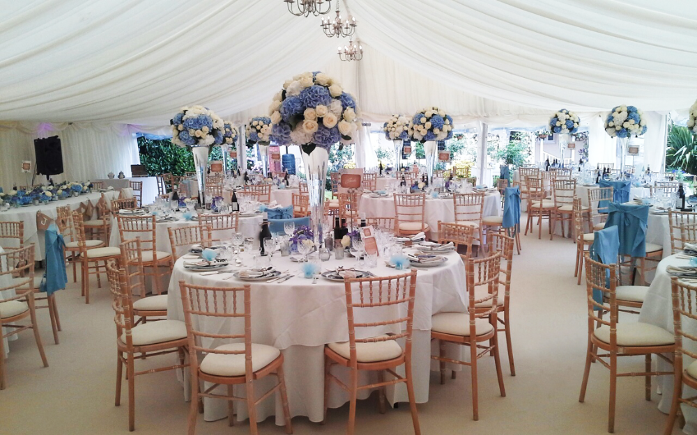 A marquee set up with chairs and tables for a wedding