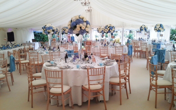 The inside of a marquee set up for a wedding banquet