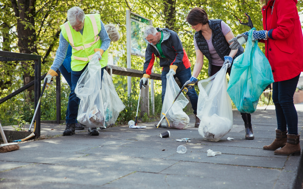 People picking up litter from a path with litter pickers