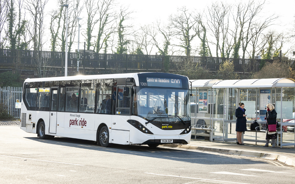 A winnersh triangle park and ride bus pulls to a stop to pick up passengers