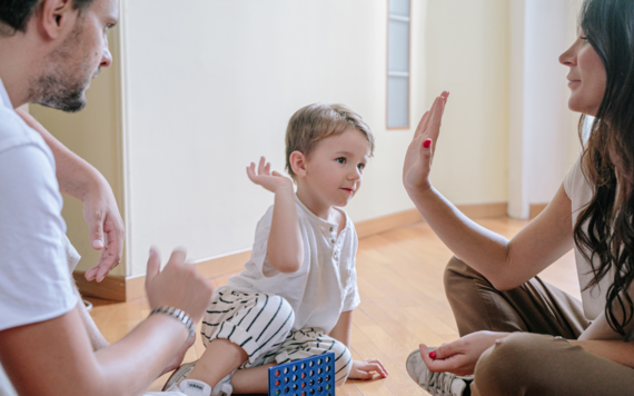 A child gives a woman a high-five