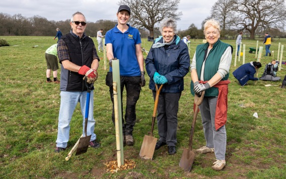 Image of people at the Covid Memorial Wood planting trees