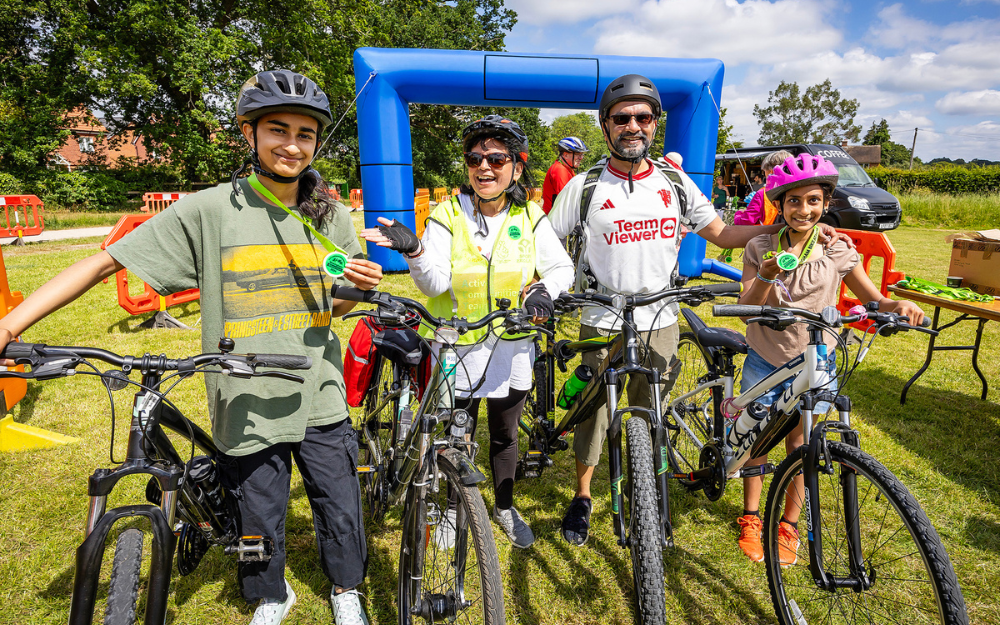 A family with their bicycles and helmets on at Wokingham Bikeathon