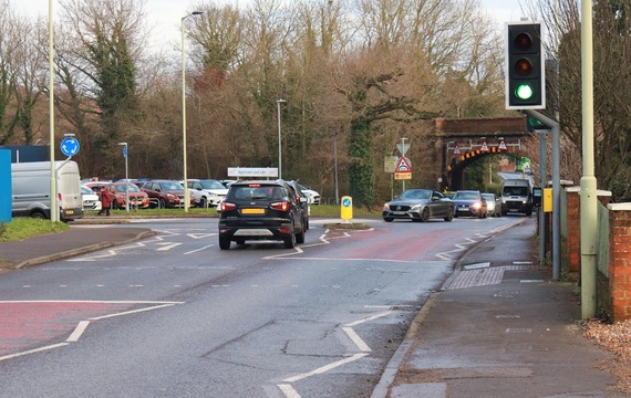 The mini roundabout at the junction of Molly Millars Lane, with railway bridge in the background