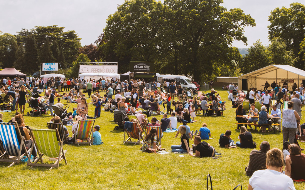 Crowds gather in groups on a sunny day at the Great British Food Festival