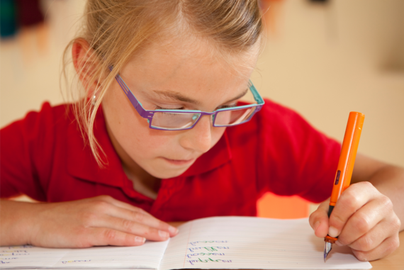 A girl concentrating on her writing