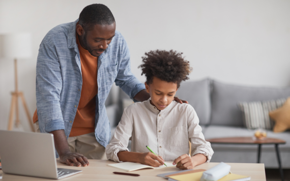 A dad helping his son with school work