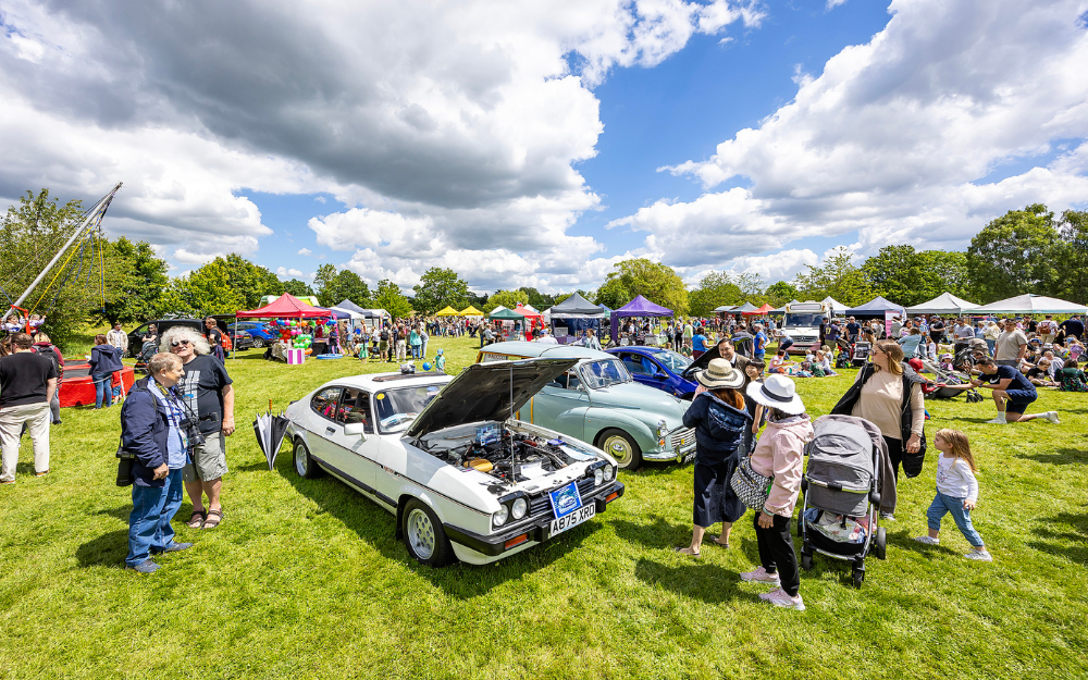Fair with classic cars and people milling around at Dinton Pastures