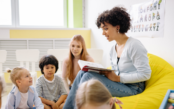 Image of a woman reading to three children