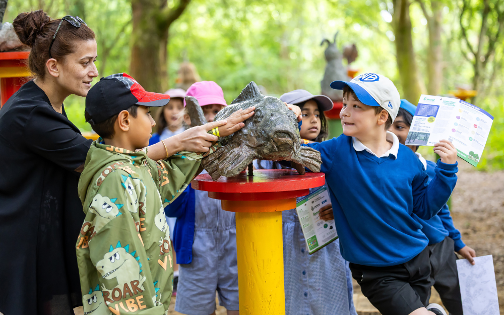Children investigating a sculpture at Dinton Pastures for Forest of Imagination