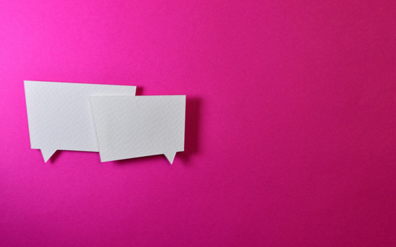 two blank speech bubbles on a bright pink background