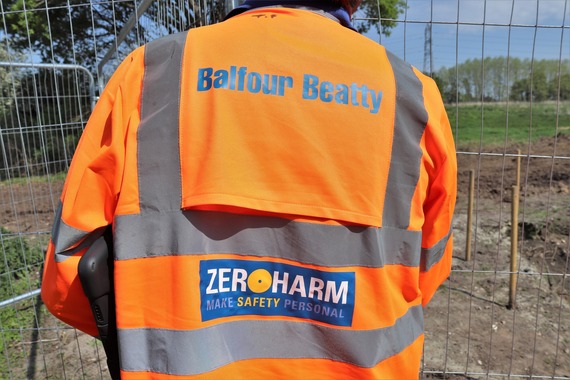 The back of a Balfour Beatty worker's orange high visibility gear with the words "Balfour Beatty. Zero harm - make safety personal"