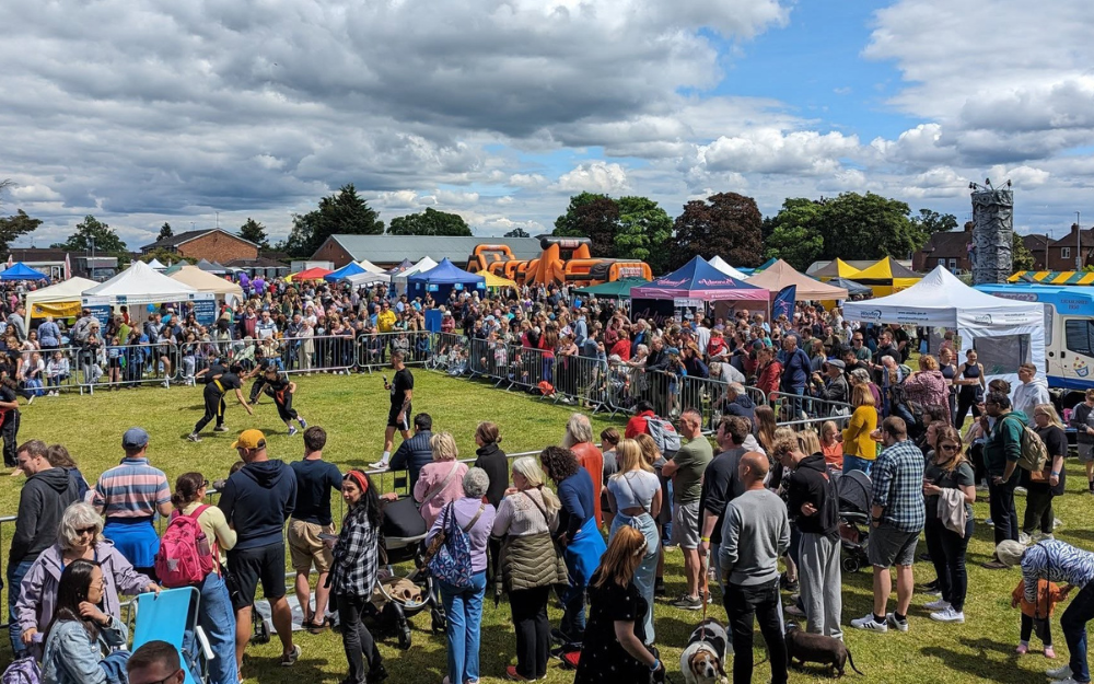 Woodley carnival arena with crowds watching stunt show