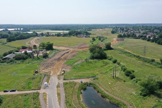 aerial photograph of a new road under construction, stretching out into fields in the background
