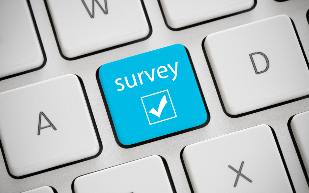 A keyboard, with the word survey on a key next to a check mark