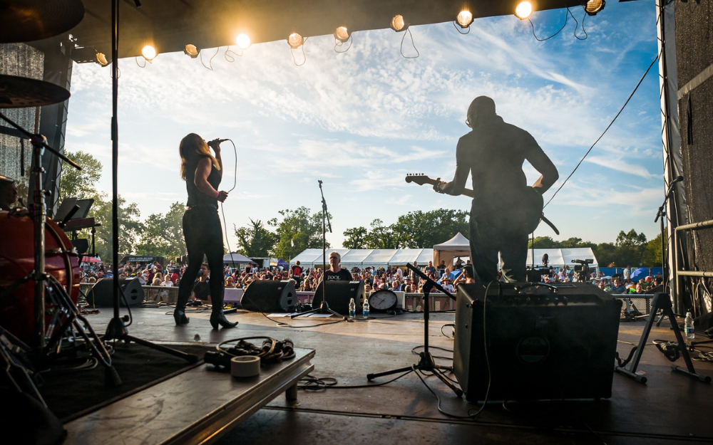 Two musicians perform on stage at Wokingham Festival