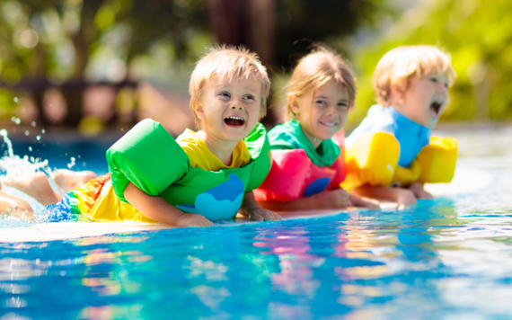 Three children in a swimming pool