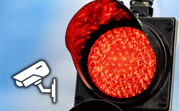 close-up photo of a red traffic light with graphic of a CCTV camera superimposed
