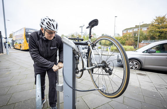Cyclist checking his bike on bike repair stand at train station