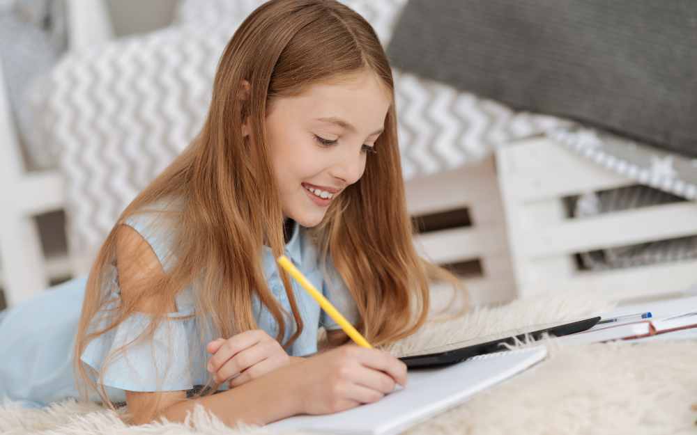 Young girl writing a story