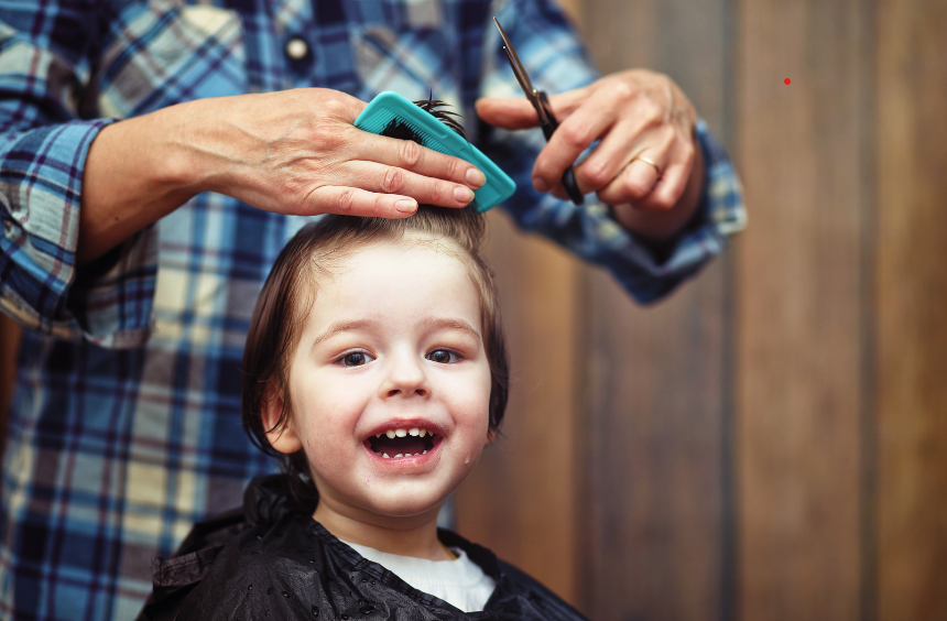 Photograph of a young child having their hair cut