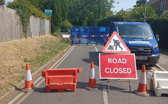 A Thames Water closure point on a quiet residential street with barriers and fencing across the road, and a Cappagh van parked behind it