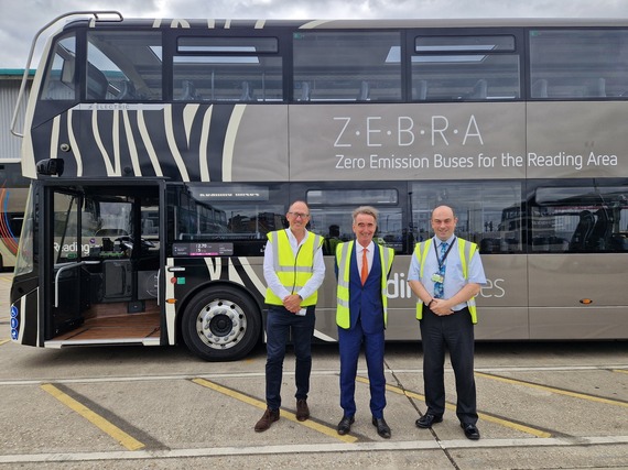 three men in high vis smile in front of a bus marked "ZEBRA - zero emission buses for the Reading area"