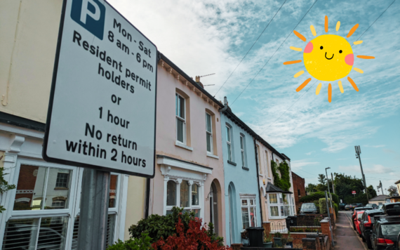 close up of a sign on a residential street showing permit parking restrictions, with a smiling cartoon sun drawn in the sky