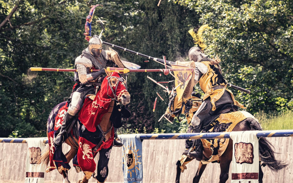 Two knights shatter their shields during a jousting match