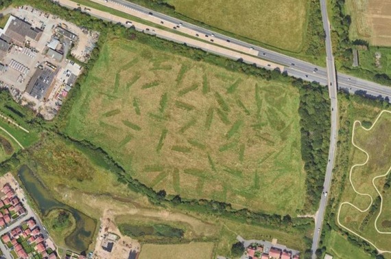 satellite view of the undeveloped field at Toutley East, with a depot to the west, the M4 to the north and Twyford Road to the east
