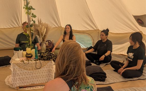 People in a teepee tent at Kamala Fest 