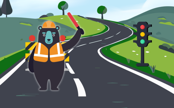 cartoon showing a cute bear in high vis stopping traffic at temporary lights for road works
