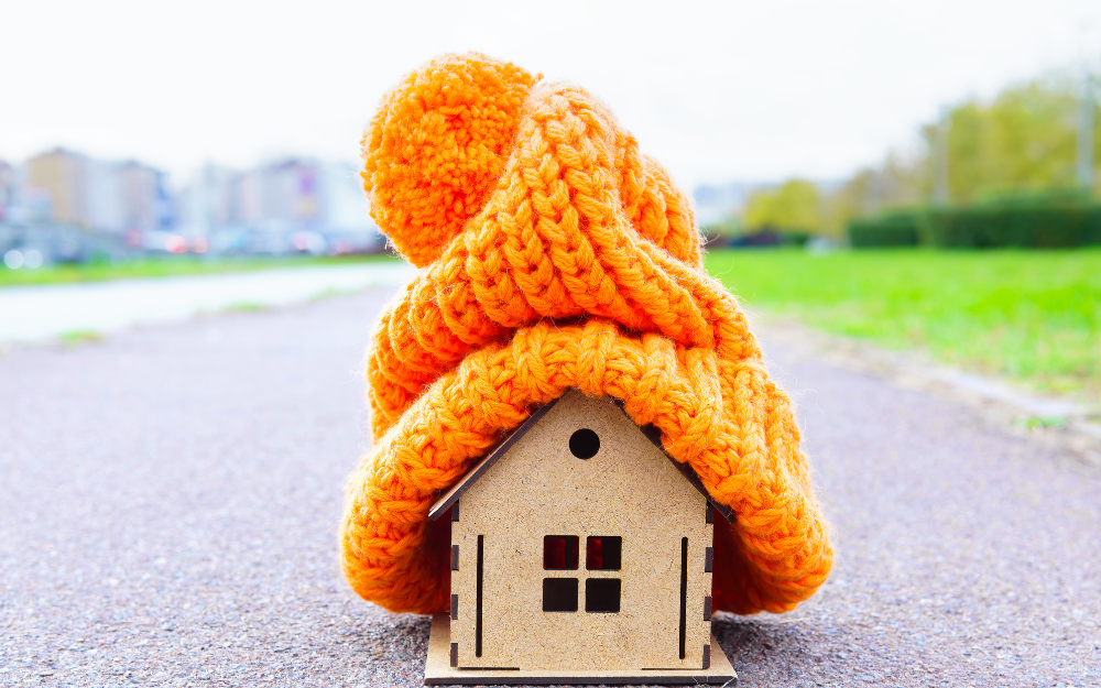 A model house with a warm knitted orange beanie hat