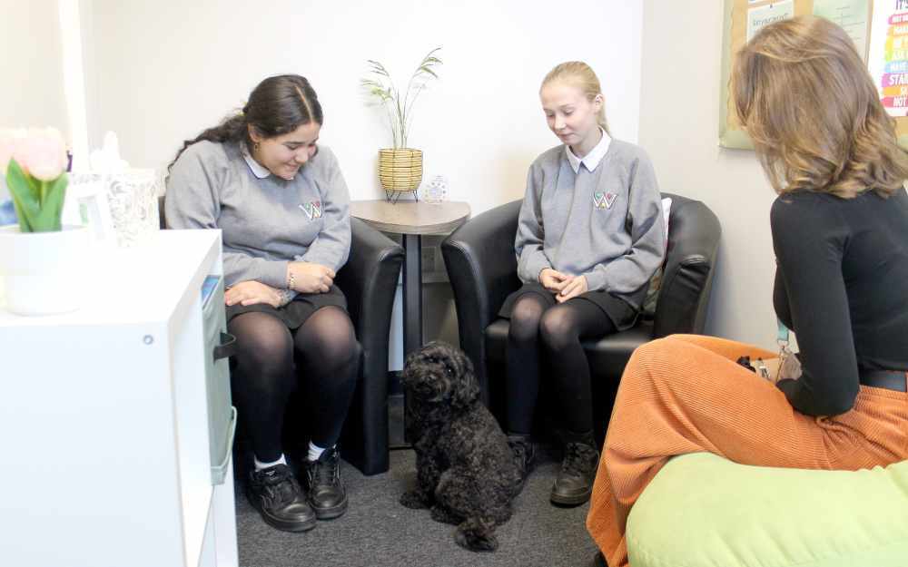 Two students with therapy dog