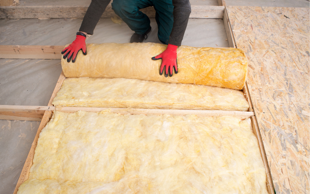 A man installs loft insulation