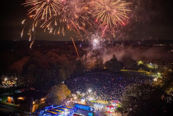 aerial image of fireworks being set off over Cantley Park with a large well-lit crowd watching on