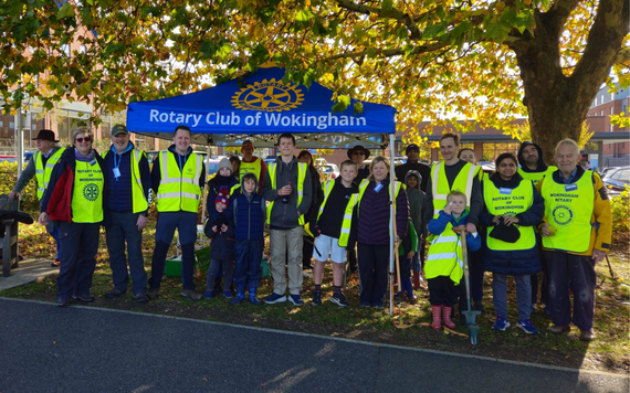 Group of volunteers in high-vis vests under a Rotary Club of Wokingham gazebo, ready for community planting at Elms Field.