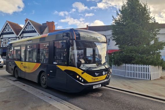 a small 151 bus to Wokingham station drives past the Christmas tree outside Wokingham town hall