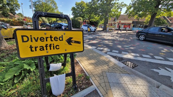a yellow sign with an arrow saying "diverted traffic" at California Crossroads in Finchampstead