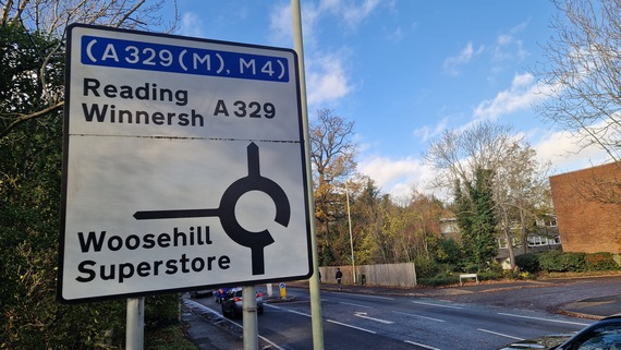 the road sign for Woosehill roundabout, approaching from the east with Winnersh ahead and the spine road on first left exit
