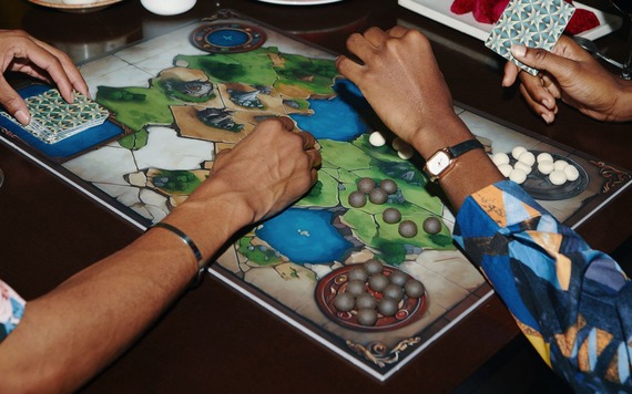 A group of people playing a board game