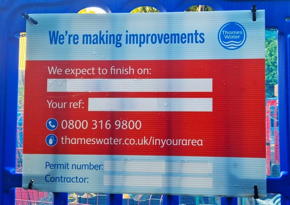 Close-up of an on-site Thames Water sign saying "we're making improvements" with details of the contractor and a phone number