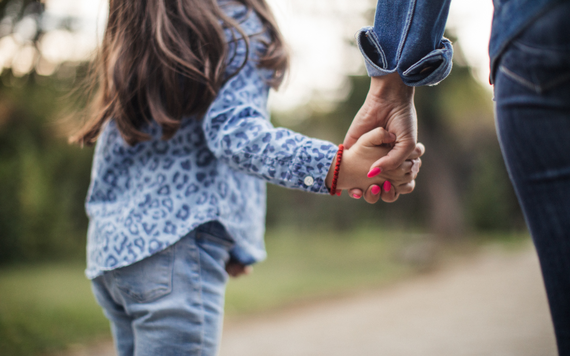 Hand holding young childs hand