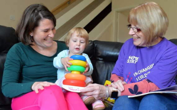 Mother and baby playing with toys