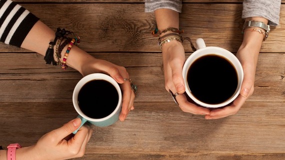 Image of coffee cups being held by two sets of hands