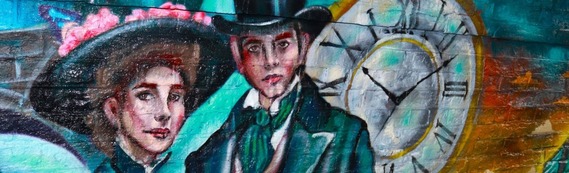 close-up of a graffiti mural showing a couple in formal Victorian wear with a large clock behind them