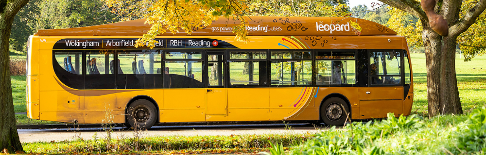 side view of the leopard 3 bus making its way through countryside in the autumn