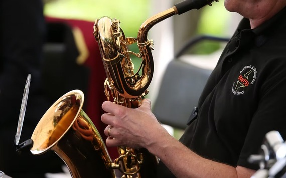 Close-up of a musician playing a gold saxophone. 