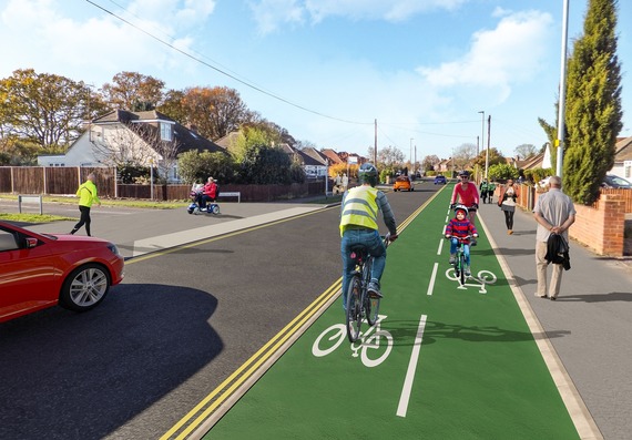 computer generated image of a two-way segregated cycle path running alongside a suburban road, with pedestrian crossings at side junctions