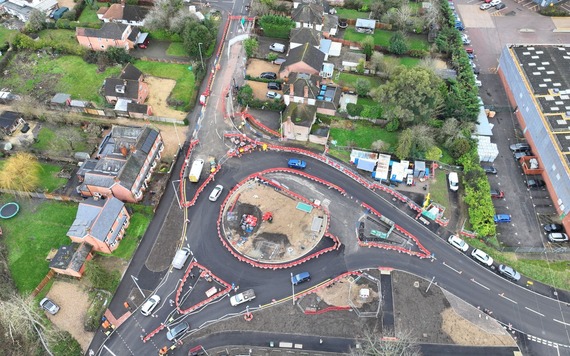 aerial photograph of a new roundabout with three exits in the final stages of construction, still with one exit closed to traffic